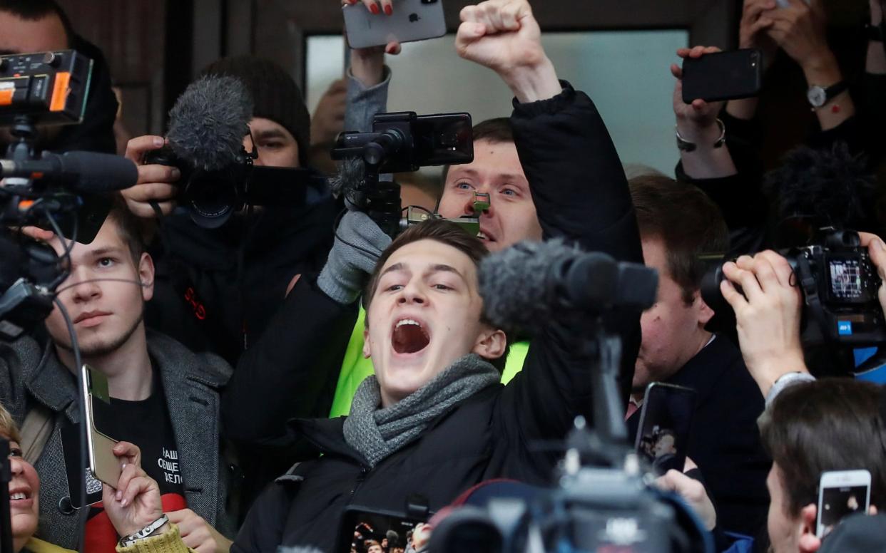 Russian protester Yegor Zhukov reacts after a court hearing in Moscow - REUTERS