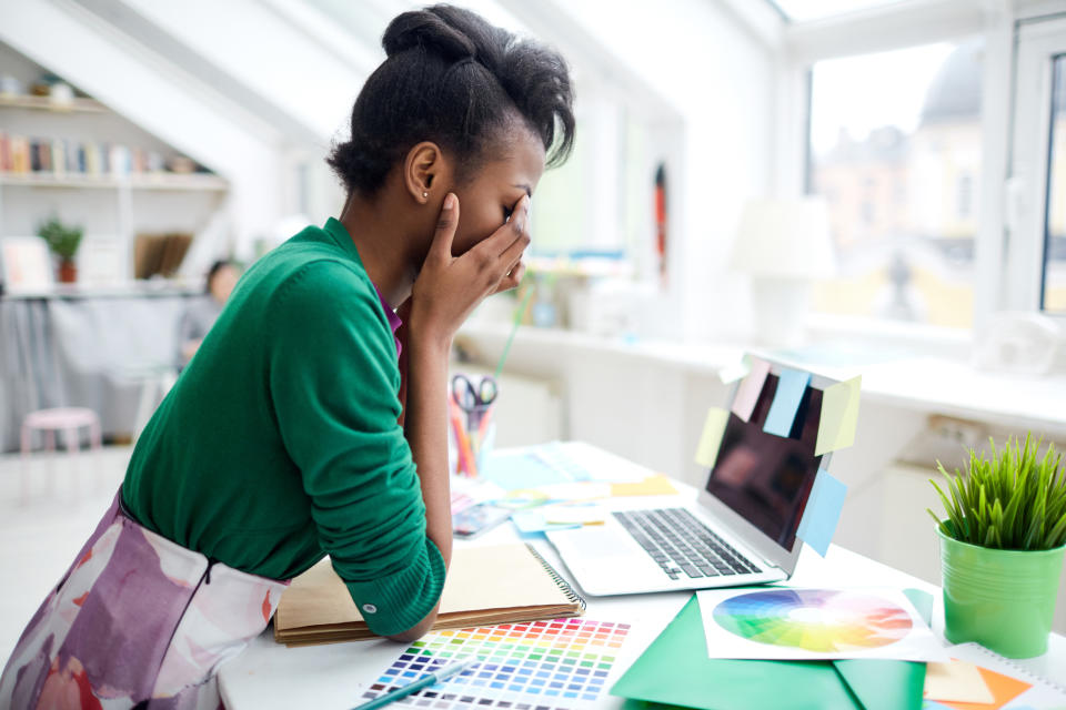 Stressed young woman at desk