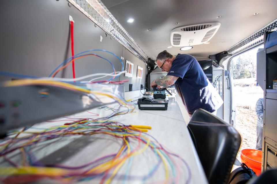 Fiber Technician Brian Messenger splices fibers in a Fort Collins Connexion repair van in this file photo.