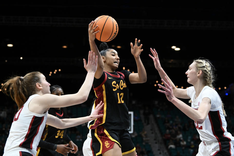 LAS VEGAS, NEVADA - MARCH 10: JuJu Watkins #12 of the USC Trojans is defended by Elena Bosgana #20 and Cameron Brink #22 of the Stanford Cardinal in the second half of the championship game of the Pac-12 Conference women's basketball tournament at MGM Grand Garden Arena on March 10, 2024 in Las Vegas, Nevada. The Trojans defeated the Cardinal 74-61. (Photo by Candice Ward/Getty Images)