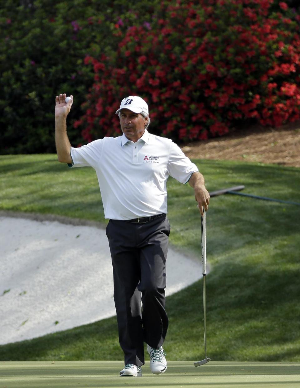 Fred Couples holds up his ball after a birdie on the 13th hole during the second round of the Masters golf tournament Friday, April 11, 2014, in Augusta, Ga. (AP Photo/David J. Phillip)