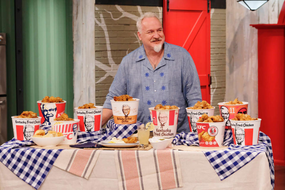 Art Smith posing with a table of KFC fried chicken