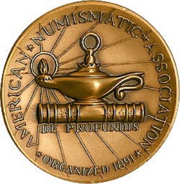 This medal created by the Medallic Art Co. represents the logo of the American Numismatic Association. The image is a lamp on top of a book. The inscription reads “De Profundis” (“from the depths”). The Medallic Art Co., founded in New York City in 1903,  was once the oldest producer of medals, awards and specialty coins. Dr. George Francis Heath of Monroe founded the American Numismatic Association in 1891.