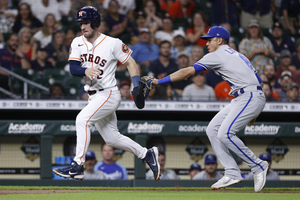 Houston Astros' Alex Bregman is caught in a rundown between third base and home plate by Kansas City Royals shortstop Nicky Lopez during the fourth inning of a baseball game Wednesday, July 6, 2022, in Houston. (AP Photo/Kevin M. Cox)