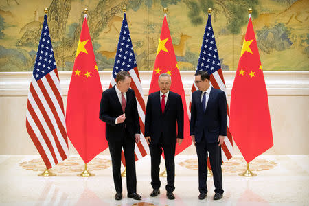 U.S. Trade Representative Robert Lighthizer, Chinese Vice Premier and lead trade negotiator Liu He, and U.S. Treasury Secretary Steven Mnuchin talk before the opening session of trade negotiations at the Diaoyutai State Guesthouse in Beijing, Thursday, Feb. 14, 2019. Mark Schiefelbein/Pool via REUTERS