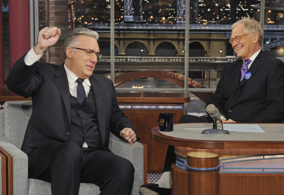 In this photo provided by CBS, talk show host Keith Olbermann, left, chats with host David Letterman on the set of the “Late Show with David Letterman,” Tuesday April 3, 2012 in New York. (AP Photo/CBS, Jeffrey R. Staab) MANDATORY CREDIT; NO ARCHIVE; NO SALES; FOR NORTH AMERICAN USE ONLY