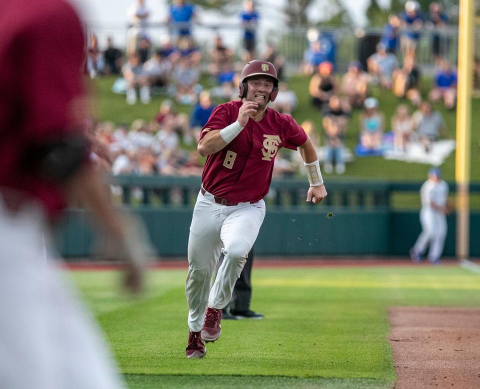 Florida State's catcher Brock Mathis (8) heads for home off Logan Lacey (32) RBI double, making it 3-1 over Florida in the top of the second inning, Tuesday, May 17, 2022, at Condron Family Ballpark in Gainesville, Florida. The Gators beat the Seminoles 7-5 with a walk-off home run by Sterlin Thompson (26) in the bottom of the ninth. [Cyndi Chambers/ Special to the Sun] 2022