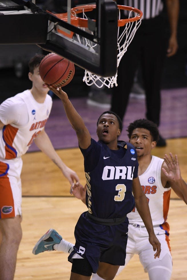 Mar 21, 2021; Indianapolis, IN, USA; Oral Roberts Golden Eagles guard Max Abmas (3) goes to the basket in the first half against the Florida Gators at Indiana Farmers Coliseum. Mandatory Credit: Doug McSchooler-USA TODAY Sports