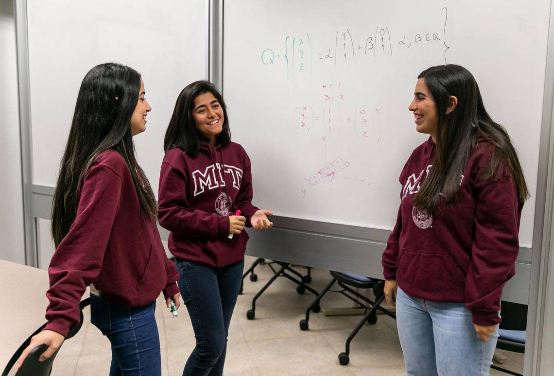 From left to right: Ana Camba Gomes, 20, Romina Cano Velasquez, 24, and Fabiana Gonzalez Zambrano, 20, write on a white board while visiting the Miami Dade College West Campus on Friday, Aug. 19, 2022, in Doral, Fla. All three, MDC Honors College students, have been accepted into the Massachusetts Institute of Technology.