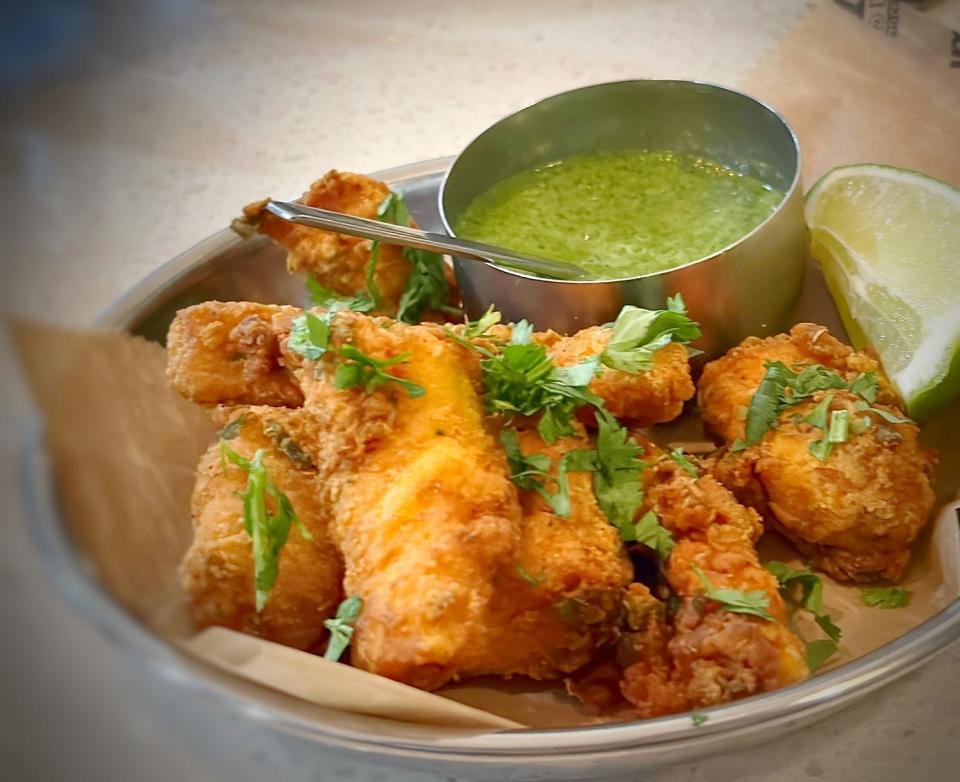 Ela Curry Kitchen's fish pakora arrives with a mint-cilantro sauce for dipping. The dish is a shareable appetizer at the Palm Beach Gardens Indian restaurant.