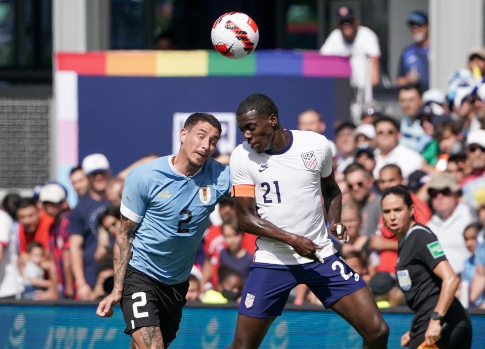 The USMNT's Tim Weah and Uruguay's Jose Gimenez head the ball during a friendly at Children's Mercy Park.