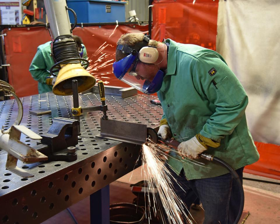 Portsmouth Naval Shipyard welder Jeremy Gearty cuts out angles on a T-bar on Thursday, June 9, 2022.