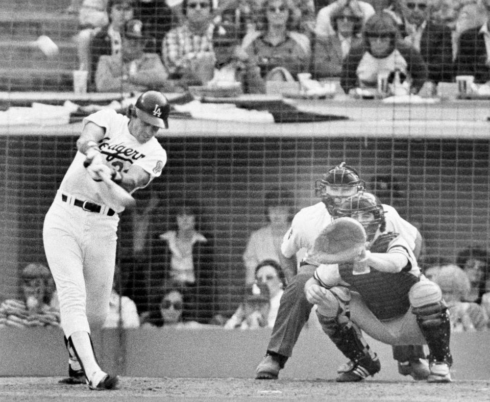 FILE - In this Oct. 24, 1981, file photo, Los Angeles Dodgers batter Jay Johnstone hits a two-run home run in the sixth inning off New York Yankees relief pitcher Ron Davis in the World Series in Los Angeles. Johnstone, who won World Series championships as a versatile outfielder with the New York Yankees and Los Angeles Dodgers while being baseball’s merry prankster, died Saturday, Sept. 26, of complications from COVID-19 at a nursing home in Granada Hills, Calif., his daughter Mary Jayne Sarah Johnstone said Monday, Sept. 28, 2020. He was 74. He also from dementia in recent years, his daughter said. (AP Photo/File)