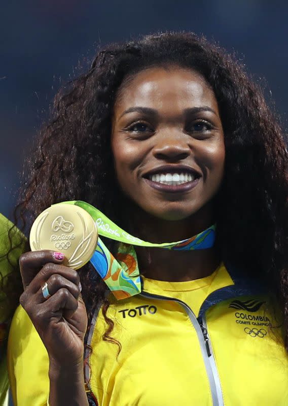 2016 Rio Olympics - Athletics - Victory Ceremony - Women's Triple Jump Victory Ceremony - Olympic Stadium - Rio de Janeiro, Brazil - 15/08/2016. Gold medalist Caterine Ibarguen (COL) of Colombia reacts after receiving her medal. REUTERS/Leonhard Foeger FOR EDITORIAL USE ONLY. NOT FOR SALE FOR MARKETING OR ADVERTISING CAMPAIGNS.