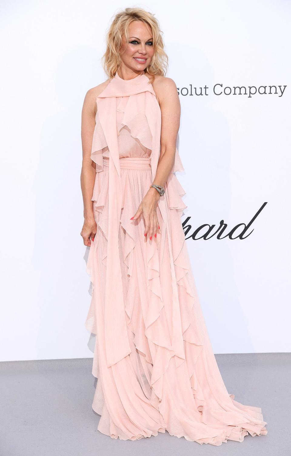 The actress wears a blush-colored pink ruffled gown with Pomellato jewels at the amfAR Gala.