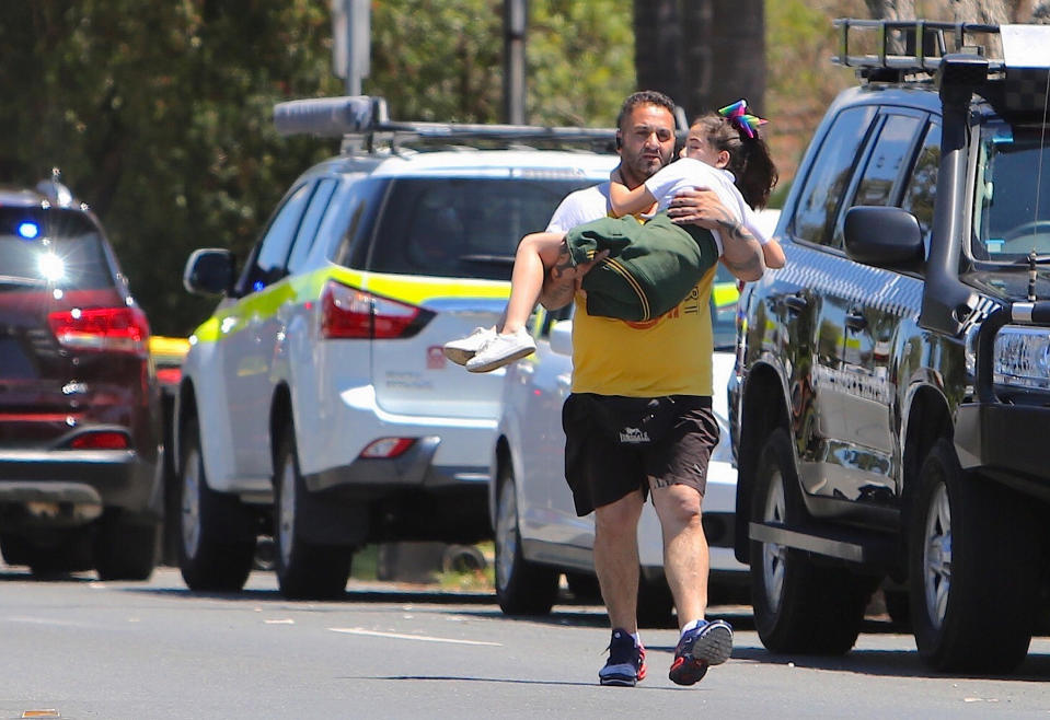 A man carries a child near the scene of the crash (Picture: Reuters)