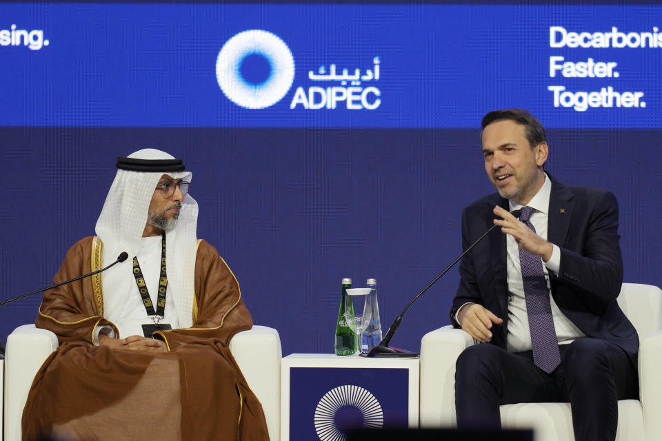 Turkish Energy Minister Alparslan Bayraktar, right, and United Arab Emirates Energy Minister Suhail al-Mazrouei attend the ADIPEC, Oil and Energy exhibition and conference in Abu Dhabi, United Arab Emirates, Monday Oct. 2, 2023. (AP Photo/Kamran Jebreili)