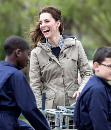 Britain's Catherine, The Duchess of Cambridge jokes with children from Vauxhall primary school after they attempted to herd a pig into a pen during a visit to a "Farms for Children" farm in Gloucestershire, May 3, 2017. REUTERS/Richard Pohle/Pool