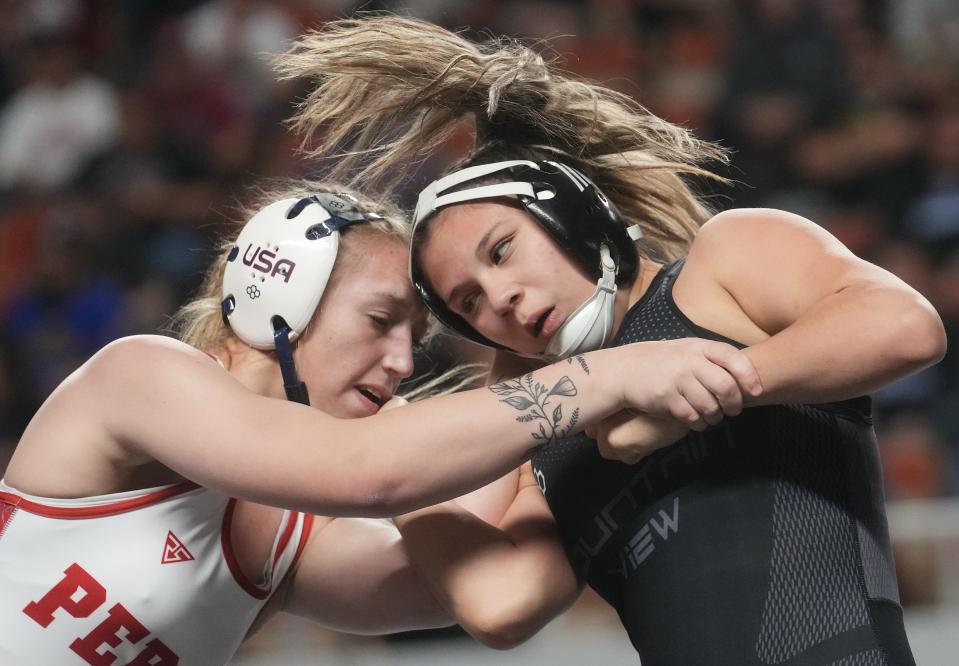 Arianna Mauch of Perry (left) wrestles Ysela Gradillas-Flores of Marana Mountain View on Feb. 17, 2024, during the State High School Wrestling Championships at Veterans Memorial Coliseum. Gradillas-Flores won the match.
