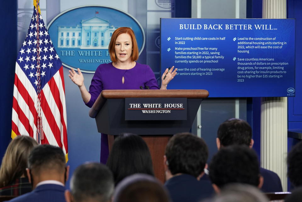 White House press secretary Jen Psaki speaks to reporters while standing behind a podium.