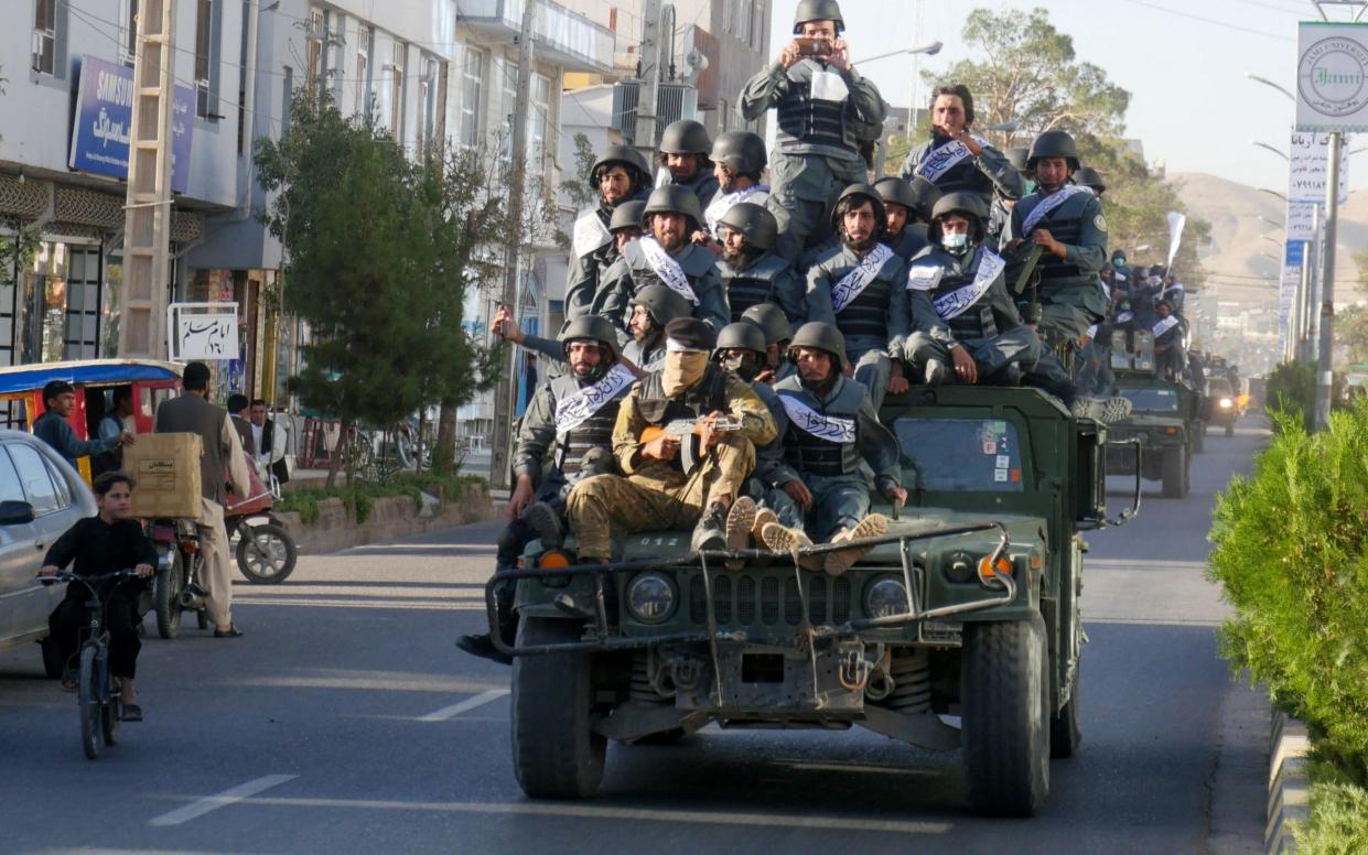 Newly recruited Taliban fighters parade in armoured vehicles after their graduation ceremony in Herat - MOHSEN KARIMI/AFP via Getty Images