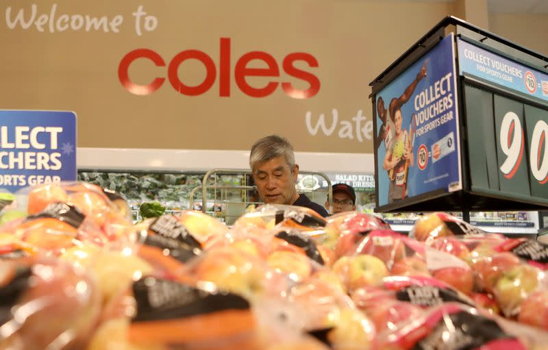 FILE PHOTO: A man walks in the fruit and vegetables section at a Coles supermarket (main Wesfarmers brand) in Sydney