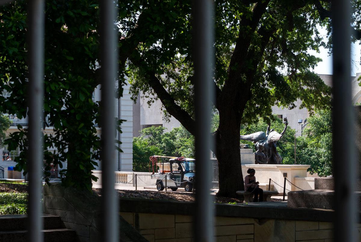 A student sits by the Littlefield Fountain at the University of Texas on May 30, 2023.