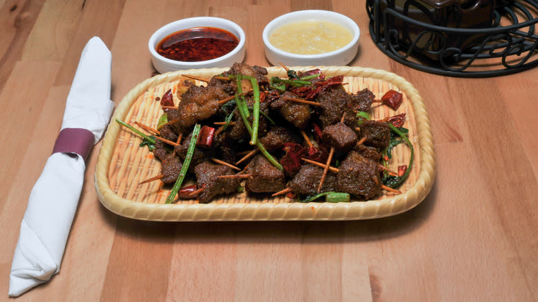 toothpick lamb on a bamboo platter