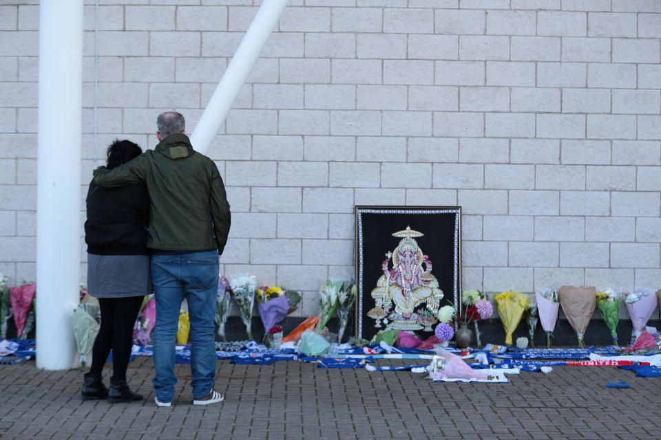 <p>Fans look on at the plethora of tributes to the Leicester City owner. Aaron Chown/PA Wire </p>