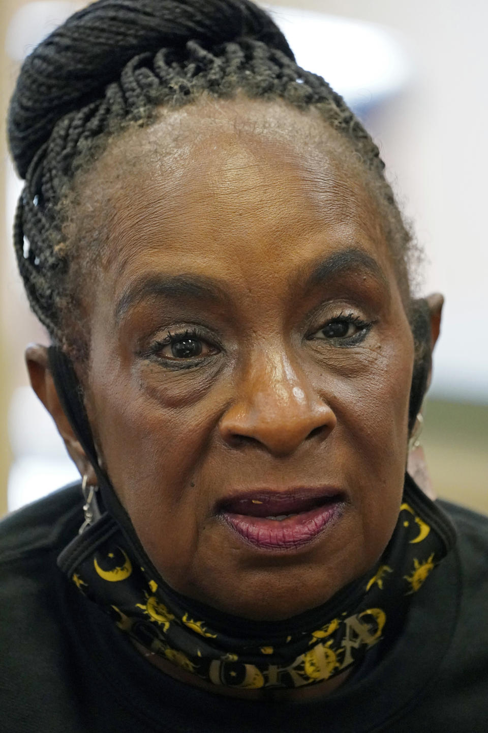 Gloria Green-McCray, sister of James Earl Green, who along with Phillip Lafayette Gibbs was killed by Mississippi Highway Patrolmen in 1970 on the campus of Jackson State University, discusses the importance quilting plays in the African American community and the significance of a quilting display on exhibit at the school, Tuesday, Nov. 30, 2021, in Jackson, Miss. A cross-stitch portrait of Green is now included with 115 others in the Stitch Their Names Memorial Project, dedicated to memorializing lives lost to racial violence in the U.S. The two quilts are open for public viewing on weekdays through Dec. 17 at Jackson State University’s Margaret Walker Center. (AP Photo/Rogelio V. Solis)