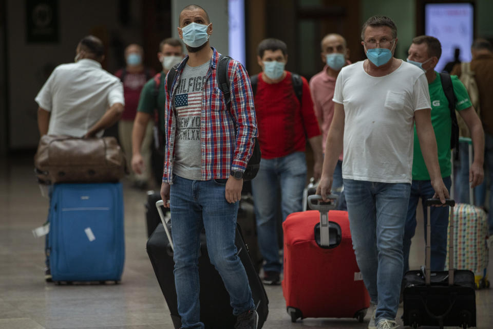 Passengers arrive at the Barcelona airport in Barcelona, Spain, Tuesday, June 30, 2020. The European Union on Tuesday is announcing a list of nations whose citizens will be allowed to enter 31 European countries. As Europe’s economies reel from the impact of the coronavirus, southern EU countries like Greece, Italy and Spain are desperate to entice back sun-loving visitors and breathe life into their damaged tourism industries. (AP Photo/Emilio Morenatti)