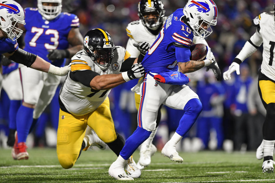 Buffalo Bills wide receiver Khalil Shakir (10) pulls free from Pittsburgh Steelers defensive tackle Cameron Heyward (97) on his way to a touchdown during the fourth quarter of an NFL wild-card playoff football game, Monday, Jan. 15, 2024, in Buffalo, N.Y. (AP Photo/Adrian Kraus)