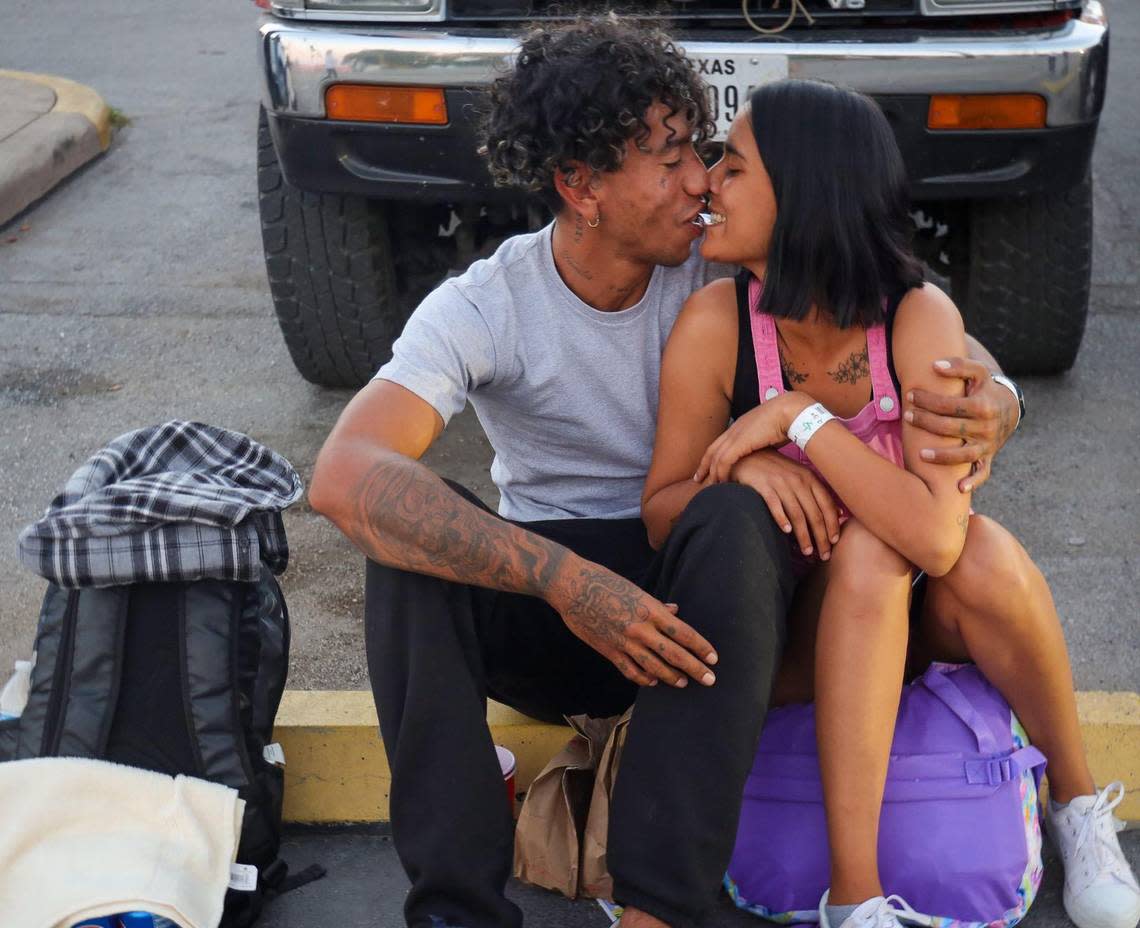 Juli Soto, 23, kisses her husband outside the San Antonio migrant shelter as the young Venezuelan couple waits for a bus to the airport to catch a flight to Miami, where they hoped to build a new life.