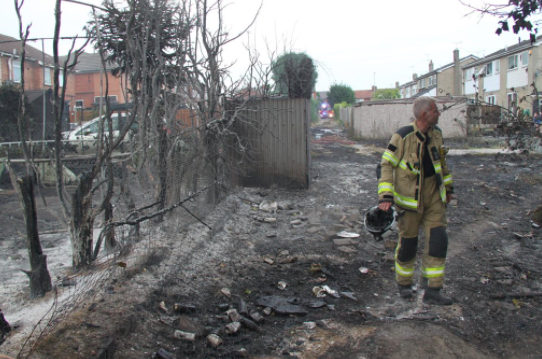 A firefighter views the scene following fires in Maltby, South Yorkshire. (South Yorkshire Fire)