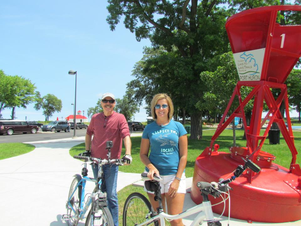 Tom Daldin, left, and Sheri Faust, right, getting ready to bike the Bridge to Bay Trail on July 12, 2023.