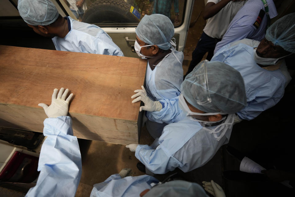 Healthcare workers carry the body of a person who died in Friday's train accident in Balasore, into an ambulance at the All India Institute of Medical Sciences hospital in Bhubaneswar in the eastern state of Orissa, India, Monday, June 5, 2023. Families of the victims of India's deadliest train crash in decades filled the hospital on Monday to identify and collect bodies of relatives, as railway officials recommended the country's premier criminal investigating agency to probe the crash that killed 275 people. (AP Photo/Rafiq Maqbool)