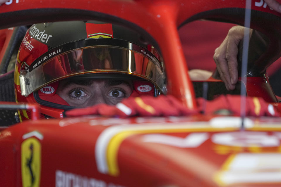 Ferrari driver Carlos Sainz of Spain waits in his car during the first practice session of the Australian Formula One Grand Prix at Albert Park, in Melbourne, Australia, Friday, March 22, 2024. (AP Photo/Asanka Brendon Ratnayake)