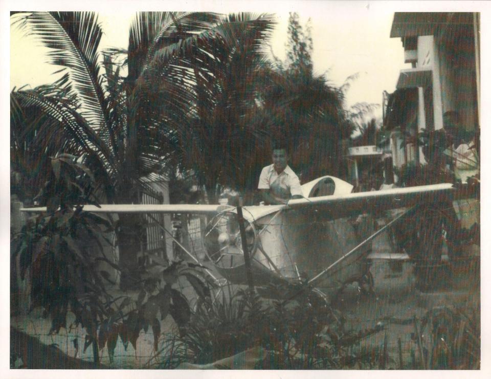 Hue Che in Nha Trang, South Vietnam, in 1962 next to a plane he assembled that never took off.