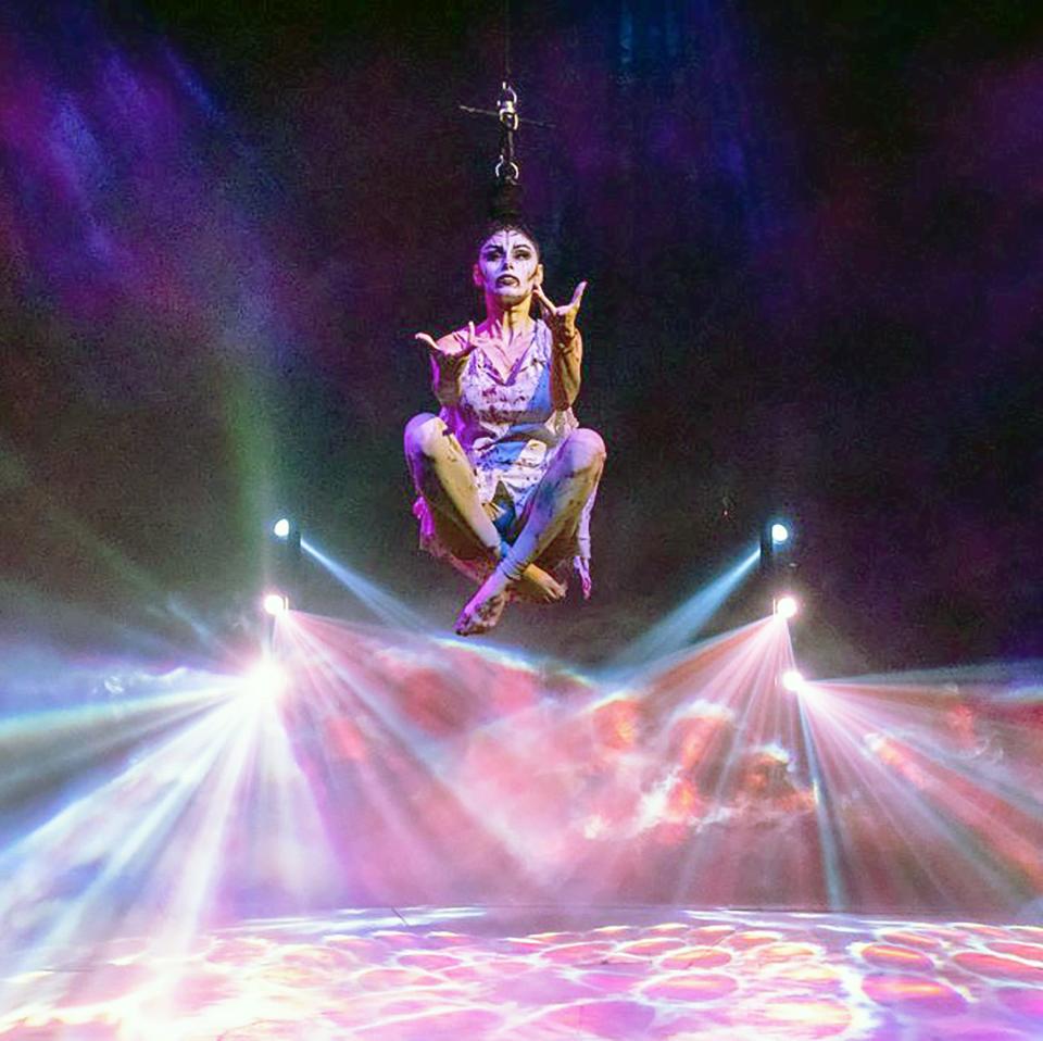 Argentina Portugal hangs by her hair during a Paranormal Cirque performance.