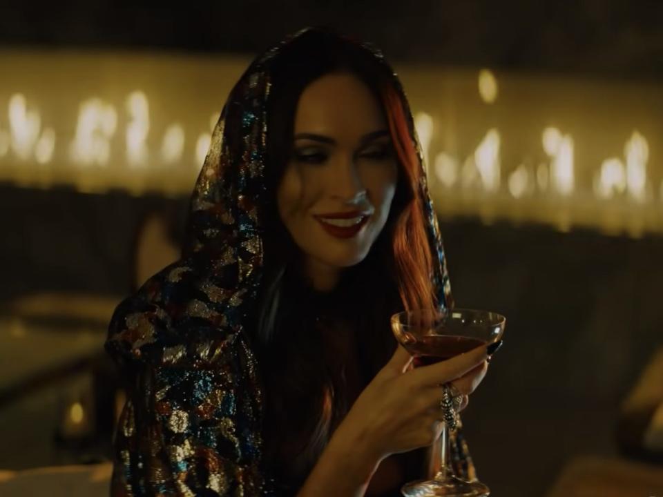 megan fox drinking a cocktail in night teeth