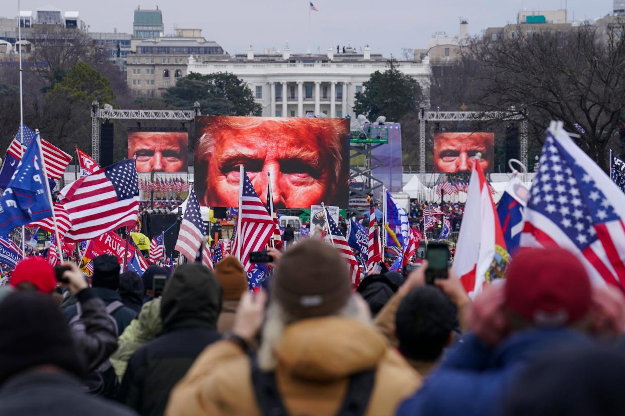 In this Jan. 6, 2021 photo, the face of President Donald Trump appears on large screens as supporters participate in a rally in Washington. The House committee investigating the violent Jan. 6 Capitol insurrection, with its latest round of subpoenas in September 2021, may uncover the degree to which former President Donald Trump, his campaign and White House were involved in planning the rally that preceded the riot, which had been billed as a grassroots demonstration.