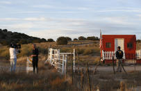 A TV news crew tapes a report at the entrance of the Bonanza Creek Film Ranch in Santa Fe, N.M. Friday, Oct. 22, 2021. Actor Alec Baldwin fired a prop gun on the set of a Western being filmed at the ranch on Thursday, Oct. 21, killing the cinematographer, officials said. The director of the movie was wounded, and authorities were investigating. (AP Photo/Andres Leighton)