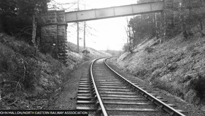 A black and white photo of a railway track 