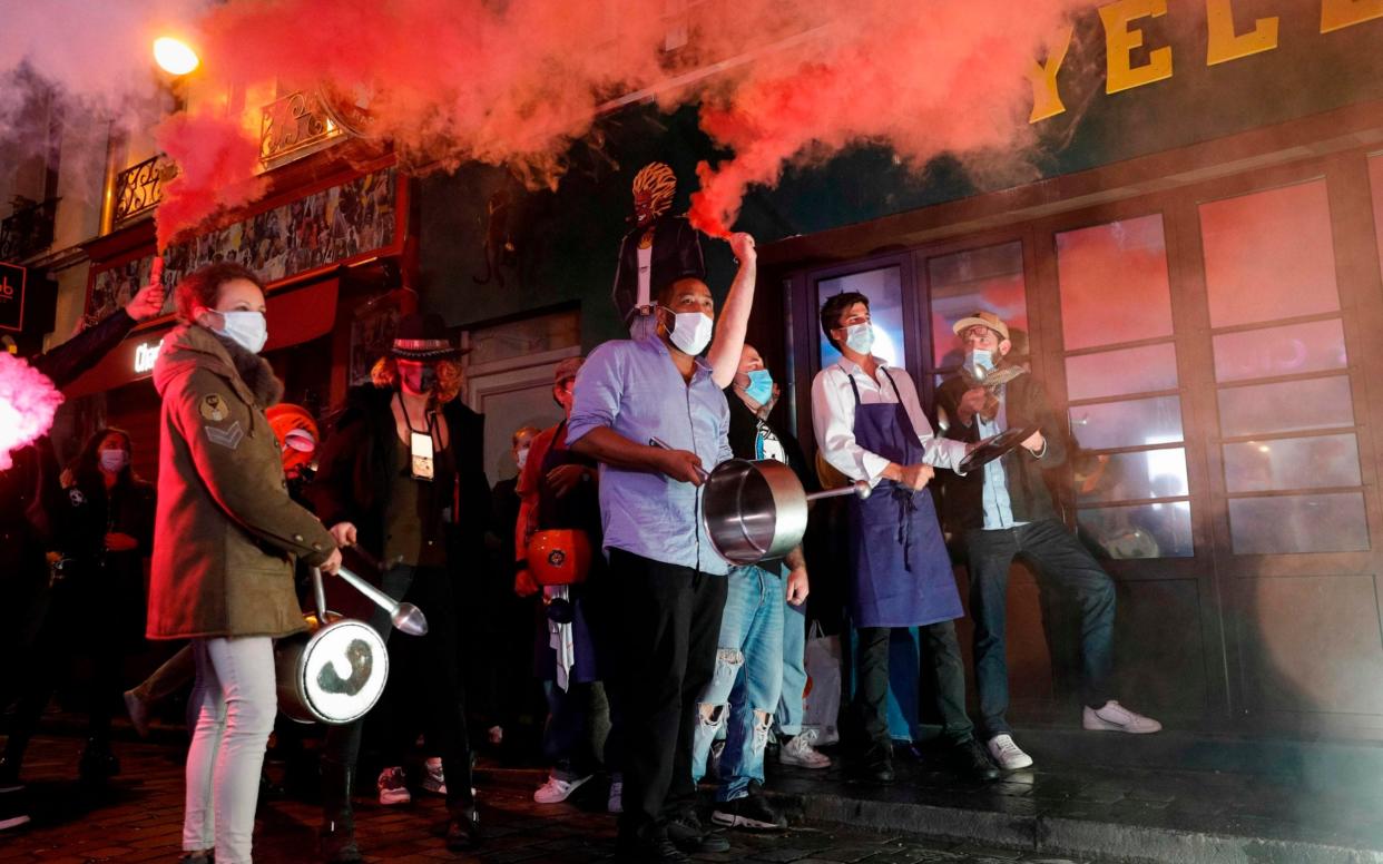 Restaurant and bar owners make noise as they protest in Paris earlier this week - GEOFFROY VAN DER HASSELT/AFP via Getty Images