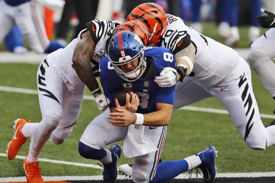 Cincinnati Bengals strong safety Vonn Bell (24) and defensive end Margus Hunt (70) sack New York Giants quarterback Daniel Jones (8) during the first half of NFL football game, Sunday, Nov. 29, 2020, in Cincinnati. (AP Photo/Aaron Doster)