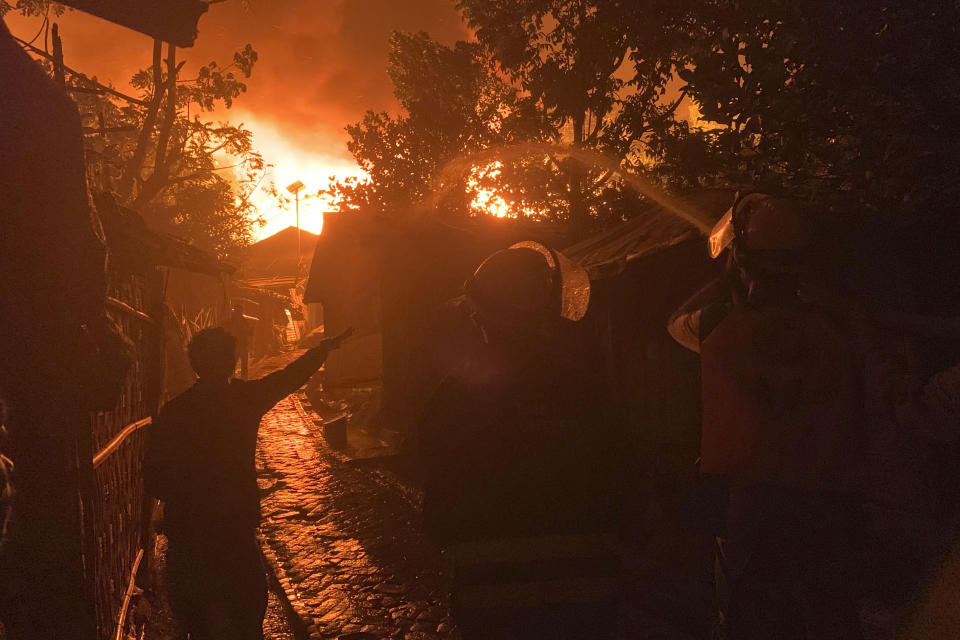 Firefighters work to douse flames at a Rohingya refugee camp at Kutupalong in Cox's Bazar district, Bangladesh, early Sunday, Jan. 7, 2024. (AP Photo/ Shafiqur Rahman)