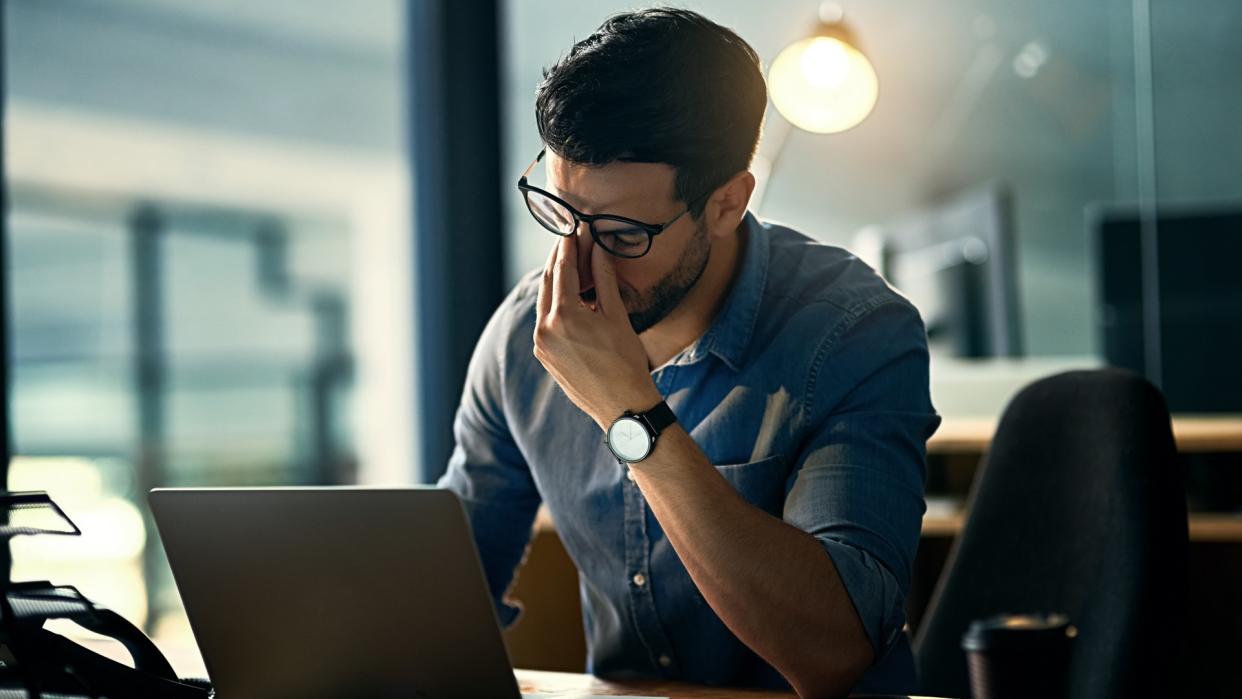 businessman experiencing stress during a late night at work