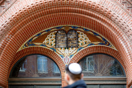 A man wearing a kippah walks past a Rykestrasse Synagogue, in Berlin, Germany, November 9, 2018. REUTERS/Fabrizio Bensch