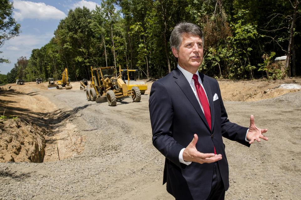 In this July 25, 2018, photo, Stephen Bell, president and CEO of the Arkadelphia Area Chamber of Commerce, talks about a new railroad spur that is being built to support the needs of what he hopes will be a new paper mill, one of several Chinese-backed deals Arkansas has landed in recent years, in Arkadelphia, Ark. State and local officials in Arkansas are scrambling to preserve development deals with Chinese companies amid President Donald Trump's escalating tariff battle. "It's like a dark cloud hanging over the future of the project," Bell said. "Right now, the clouds are off on the horizon. But I think no one knows where the trade situation is going right now." (AP Photo/Karen E. Segrave)