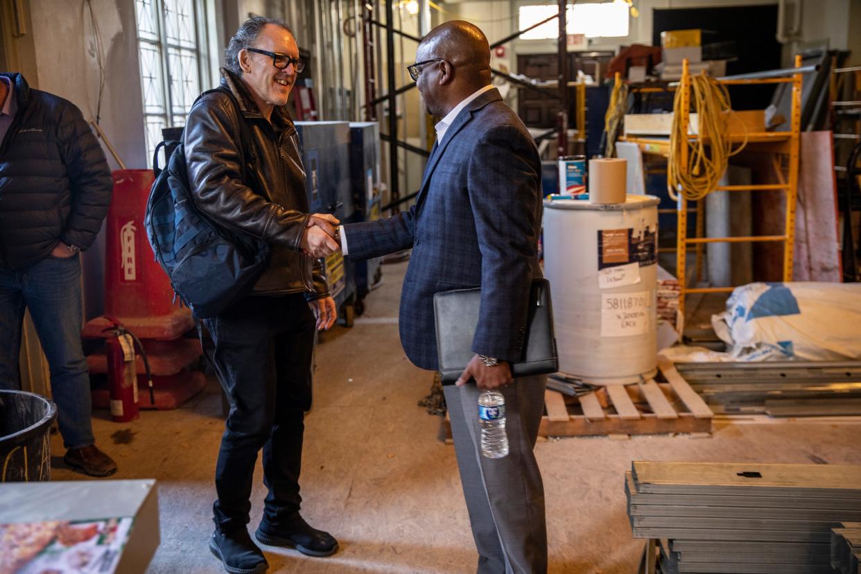 Shaun Wilson, right, founder and managing partner at Cadence, shakes hands with his client Christopher Collins, artistic director of the Detroit Jazz Festival Foundation, before doing a walk-through of the restoration process of the new Gretchen C. Valade Jazz Center on Wayne State University in Detroit, on Tuesday, Nov. 7, 2023.